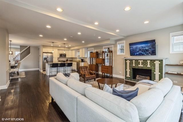 living room featuring a fireplace and dark hardwood / wood-style floors