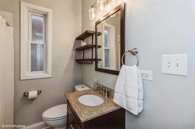 bathroom with toilet and vanity