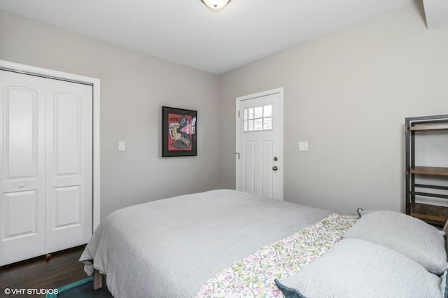 bedroom with a closet and dark wood-type flooring