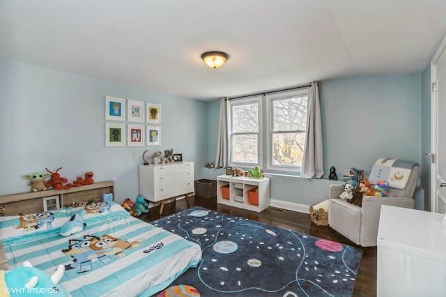 bedroom with dark hardwood / wood-style flooring