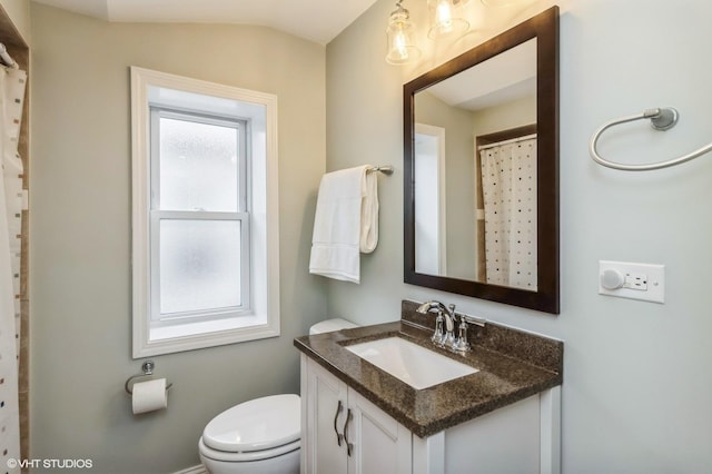 bathroom featuring curtained shower, toilet, vanity, and lofted ceiling