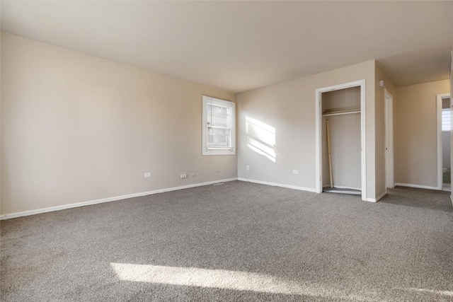 unfurnished bedroom with carpet floors and multiple windows