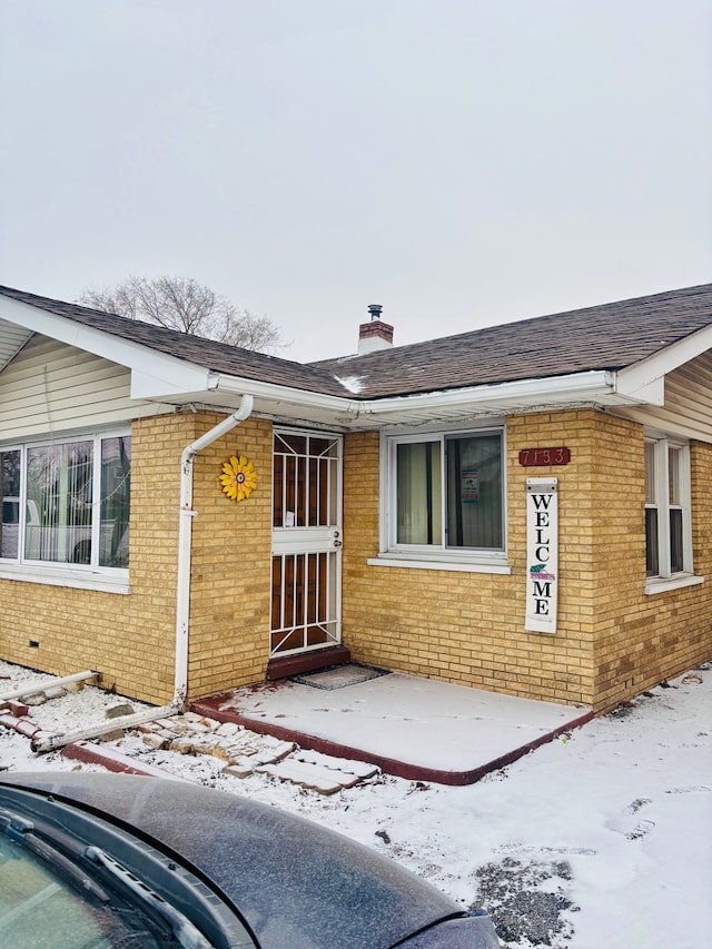 view of snow covered property entrance