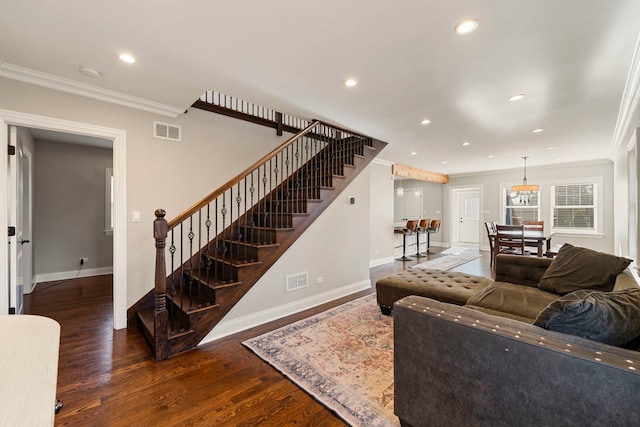 living room featuring dark wood-type flooring and crown molding