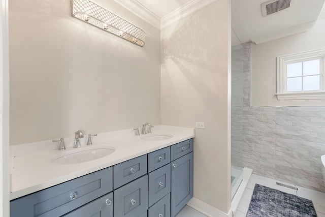 bathroom featuring tiled shower, vanity, and ornamental molding