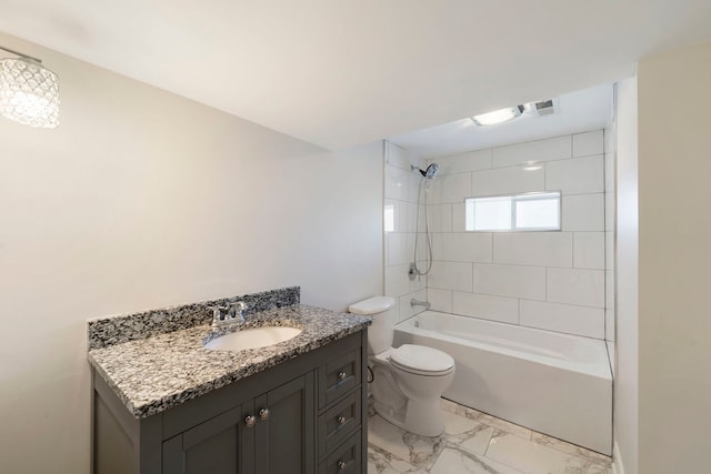 full bathroom with toilet, tiled shower / bath, and vanity