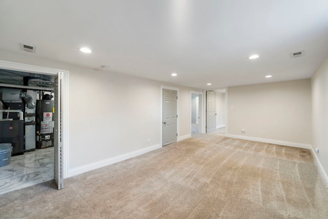 basement featuring light carpet and gas water heater