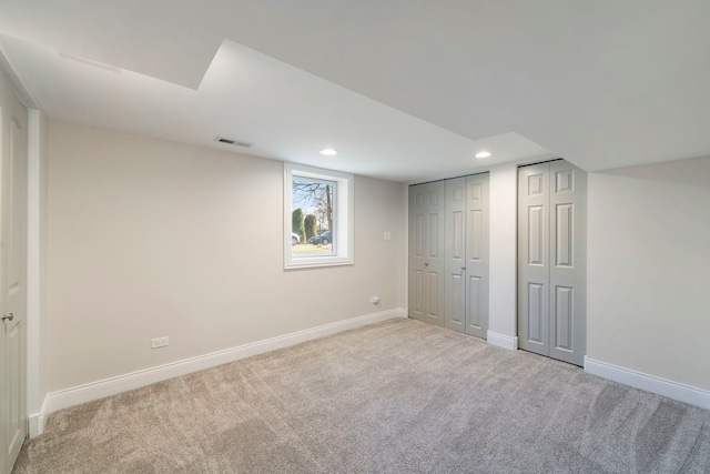 basement featuring light colored carpet