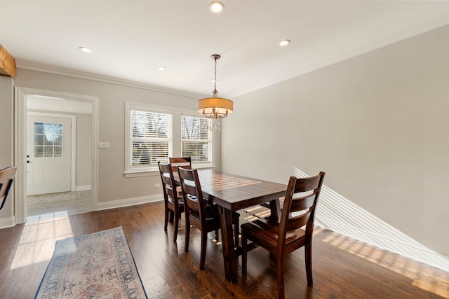 dining area featuring dark hardwood / wood-style floors and ornamental molding