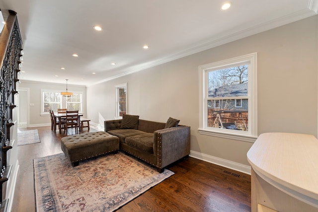 living room featuring dark hardwood / wood-style flooring and crown molding