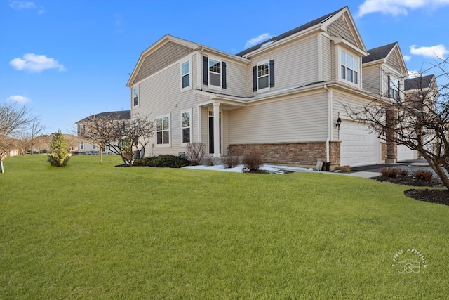 view of front of property with a garage and a front lawn