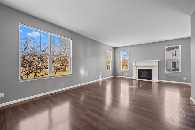 unfurnished living room with dark hardwood / wood-style floors