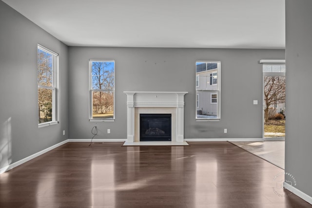 unfurnished living room with dark hardwood / wood-style flooring