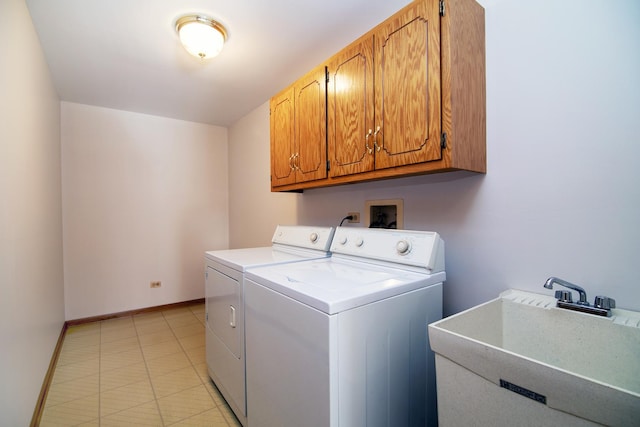 laundry area featuring cabinets, independent washer and dryer, and sink