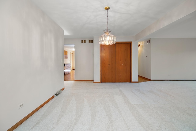 unfurnished room featuring light colored carpet