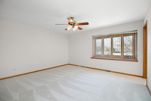 spare room with light carpet and ceiling fan