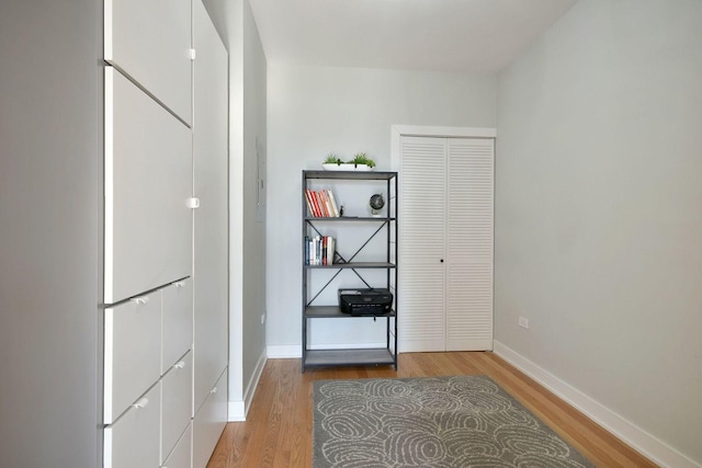 hallway with hardwood / wood-style flooring