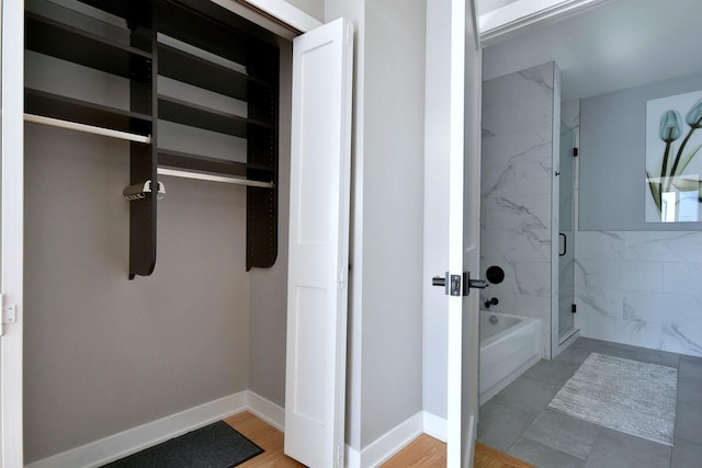 bathroom featuring separate shower and tub