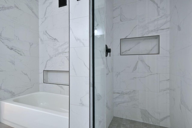 bathroom with a tile shower