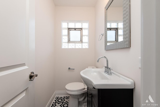 bathroom featuring toilet and vanity