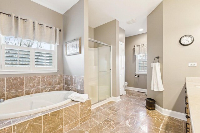 bathroom with a whirlpool tub and a stall shower