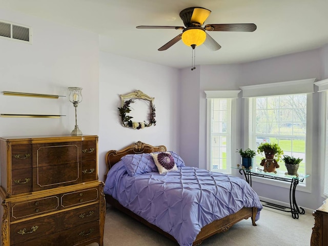 bedroom with visible vents, a ceiling fan, and carpet
