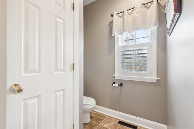 bathroom with baseboards, tile patterned flooring, toilet, and visible vents