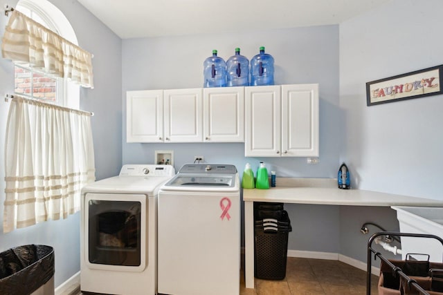 clothes washing area with light tile patterned floors, separate washer and dryer, cabinet space, and baseboards