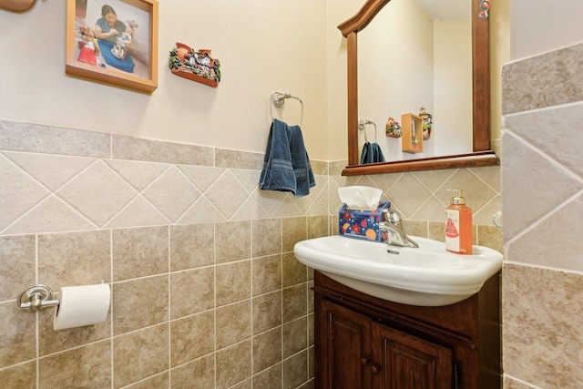 bathroom with vanity and tile walls