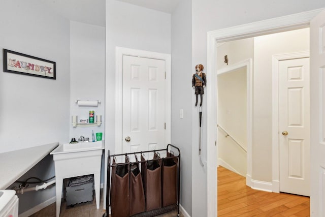 hall featuring baseboards and light wood-style flooring