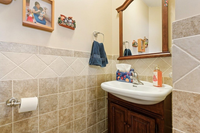 bathroom featuring vanity and tile walls
