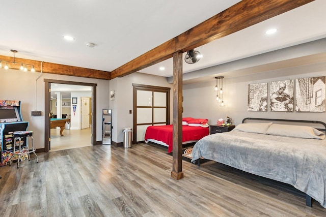 bedroom featuring beam ceiling, baseboards, wood finished floors, and recessed lighting