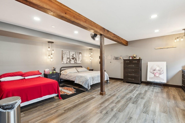 bedroom with recessed lighting, baseboards, wood finished floors, and beam ceiling
