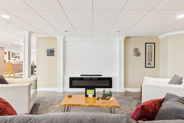 recreation room featuring baseboards, ornamental molding, and recessed lighting