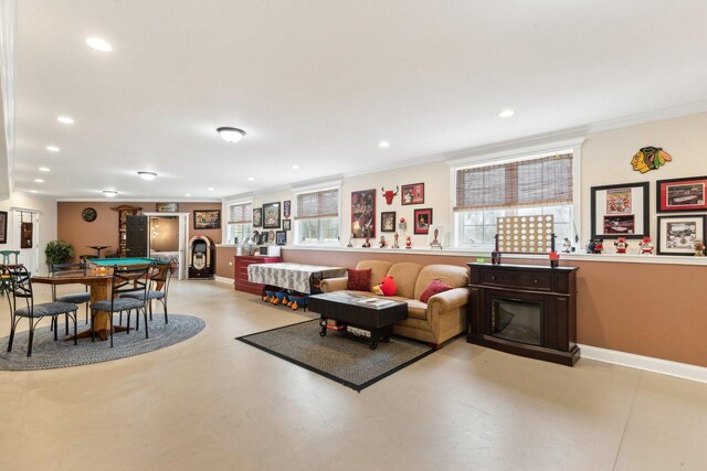 living room with ornamental molding, recessed lighting, baseboards, and stairs