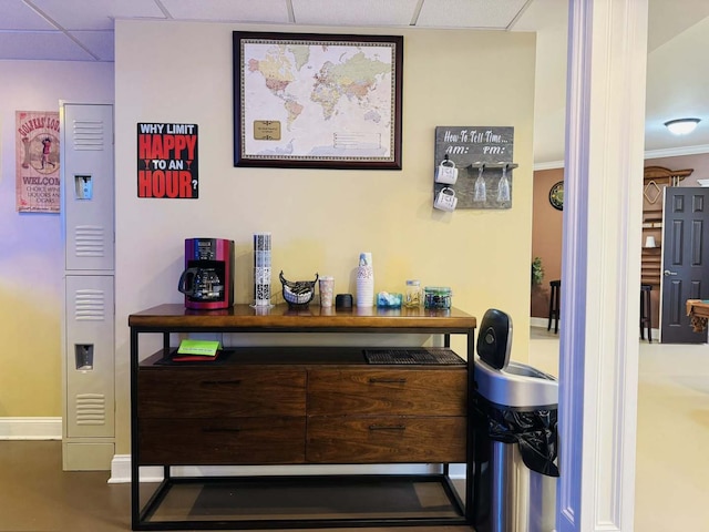 bar with baseboards and a drop ceiling