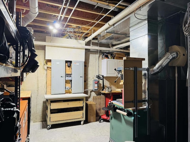 unfinished basement featuring electric panel and a workshop area