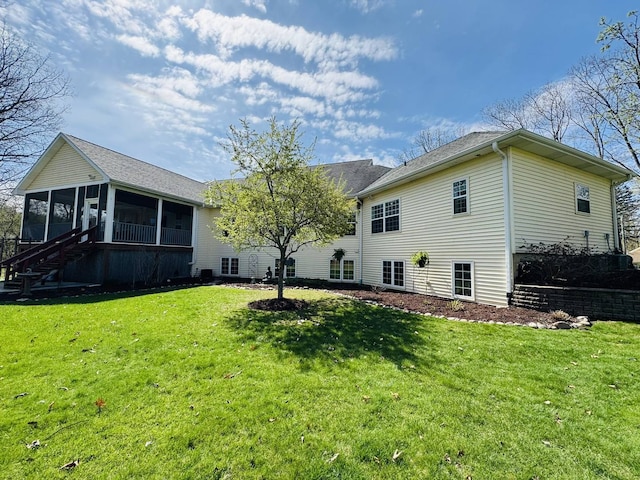 back of house with a lawn and a sunroom