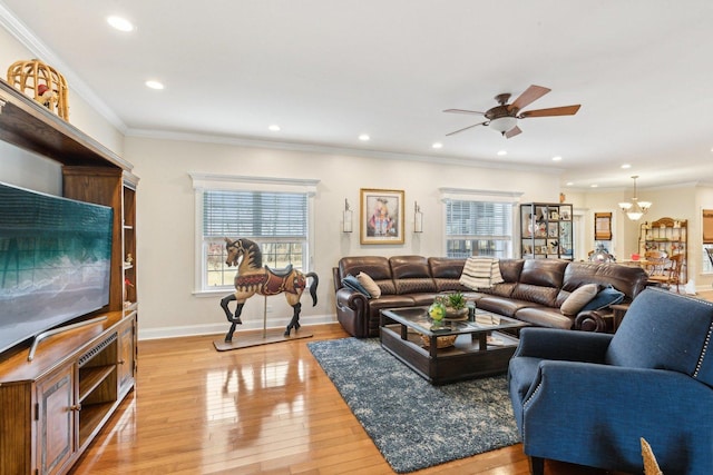 living room with recessed lighting, crown molding, light wood-style flooring, and baseboards