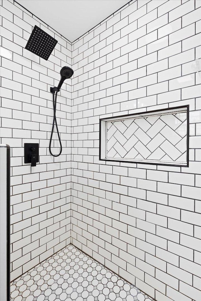 bathroom with a tile shower