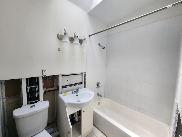 bathroom with toilet, tile patterned flooring, and tiled shower / bath