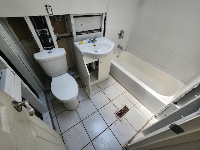 bathroom featuring toilet, tile patterned floors, and tiled shower / bath