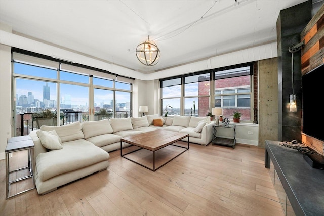 living room featuring a chandelier and light hardwood / wood-style floors