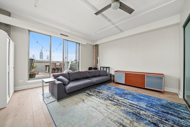 living room featuring ceiling fan, a wealth of natural light, and hardwood / wood-style floors