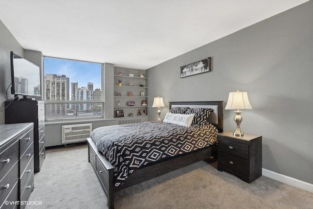 carpeted bedroom with a wall unit AC