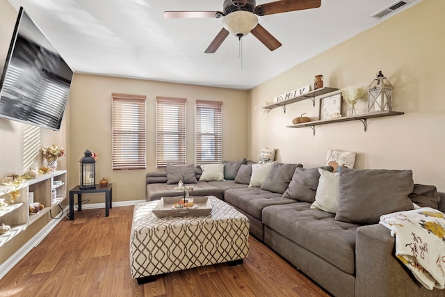 living room featuring ceiling fan and hardwood / wood-style floors