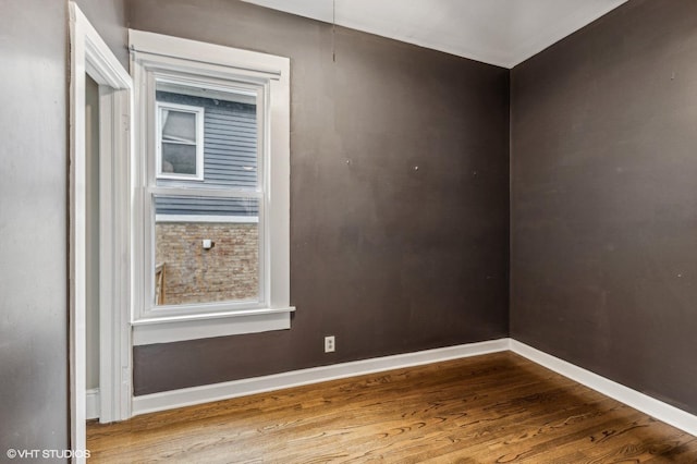 unfurnished room with wood-type flooring