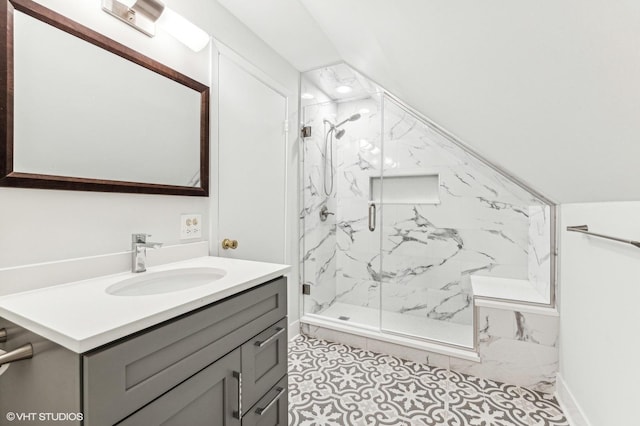 bathroom featuring walk in shower, vanity, and vaulted ceiling