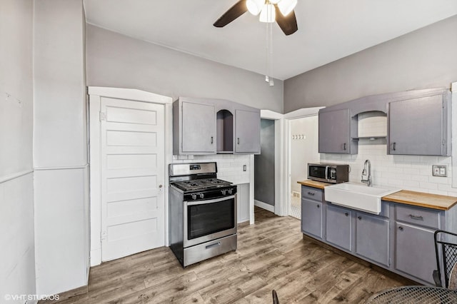 kitchen with stainless steel appliances, gray cabinetry, and sink