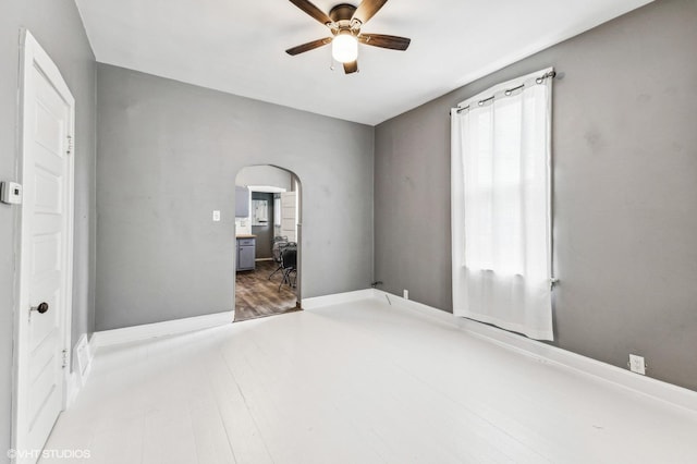 unfurnished room with ceiling fan and hardwood / wood-style flooring